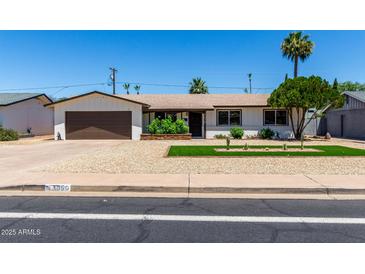 Charming single-story home featuring a well-manicured yard and a two-car garage at 3050 E Cholla E St, Phoenix, AZ 85028