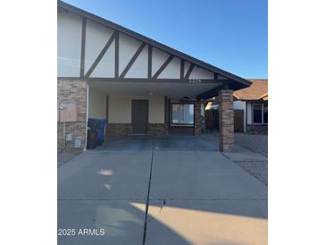 Charming single-story home featuring a covered carport and well-maintained front yard at 3328 E Crescent Ave, Mesa, AZ 85204