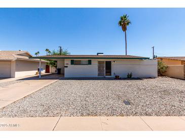 Charming single-story home featuring low-maintenance desert landscaping and a covered carport at 539 E Pebble Beach Dr, Tempe, AZ 85282