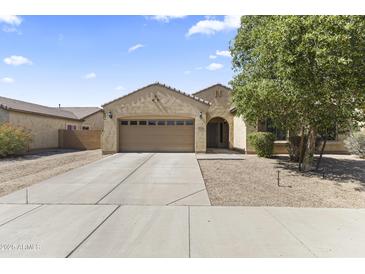 Charming single-story home with a two-car garage and a well-maintained landscaped front yard at 16762 W Sonora St, Goodyear, AZ 85338