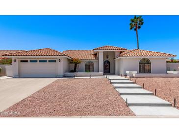 Charming home featuring a red tile roof, desert landscaping, and a welcoming front entrance at 17025 E De Anza Dr, Fountain Hills, AZ 85268