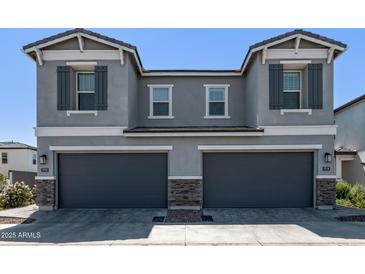 Beautiful gray home with gray garage doors and stone accents enhancing curb appeal at 17118 N 50Th Way, Scottsdale, AZ 85254
