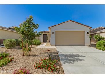 Charming single-story home featuring low maintenance landscaping and a two-car garage at 17444 W Via De Luna Dr, Surprise, AZ 85387