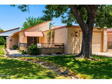 Charming single-story home featuring an attached garage, inviting entrance, and mature landscaping at 212 Leisure World --, Mesa, AZ 85206