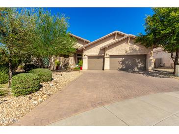 Charming home featuring a paved driveway and a well-maintained front yard at 27713 N 57Th Dr, Phoenix, AZ 85083