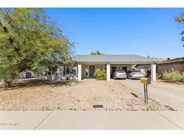 Charming single-story home with desert landscaping and a covered parking area for two vehicles at 3505 S Westfall Ave, Tempe, AZ 85282
