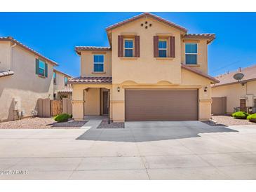 Inviting two-story home featuring a well-kept yard, two-car garage and appealing desert landscape at 5113 E Greenway E St, Mesa, AZ 85205