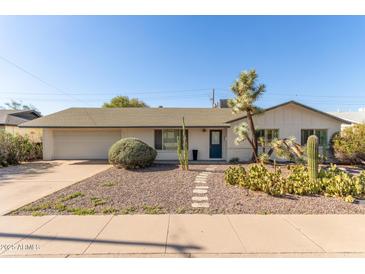 Charming single-story home featuring desert landscaping and a cozy entrance walkway at 6820 E Pinchot Ave, Scottsdale, AZ 85251