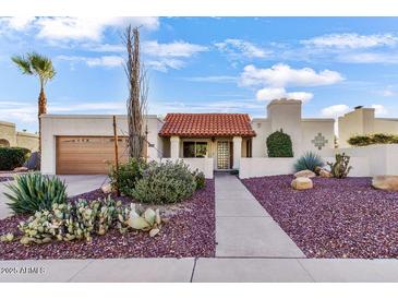 Charming single-story home featuring desert landscaping and a terracotta tile roof at 7610 N Via De Manana Dr, Scottsdale, AZ 85258