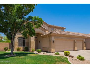 Inviting two-story home with a three-car garage and well-manicured lawn at 986 W Citrus Way, Chandler, AZ 85248