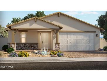 Charming single-story home with a well-manicured lawn and a two-car garage at 17524 W Woodlands Ave, Goodyear, AZ 85338