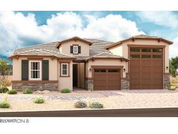 Charming single-story home with a three-car garage, stone accents, neutral colors, and well-maintained landscaping at 20158 W Monterey Way, Buckeye, AZ 85396