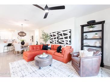 Inviting living room features an orange sectional sofa, stylish decor, and an open-concept design at 2511 W Queen Creek Rd # 325, Chandler, AZ 85248