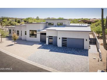 Stunning contemporary home featuring a stylish gray driveway and xeriscaped front yard at 28349 N 113Th St, Scottsdale, AZ 85262
