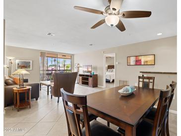 Spacious living and dining area featuring neutral tones and access to an outdoor balcony at 4200 N Miller Rd # 408, Scottsdale, AZ 85251