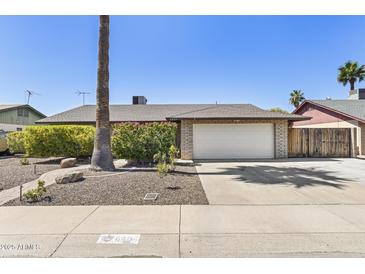 Charming single-story home featuring a well-maintained front yard and two-car garage at 6605 W Altadena Ave, Glendale, AZ 85304