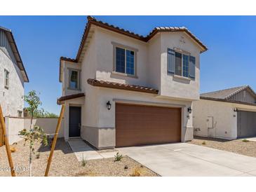 Charming two-story home with a two-car garage and desert landscaping at 9412 E Sequence Ave, Mesa, AZ 85212