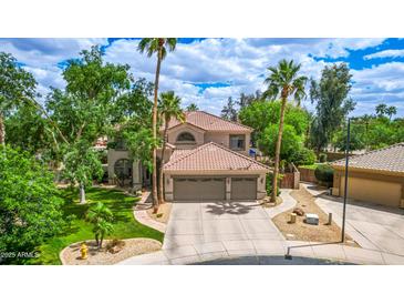 Stunning two-story home featuring a spacious three-car garage and beautifully landscaped front yard at 1571 E Saratoga Ct, Gilbert, AZ 85296