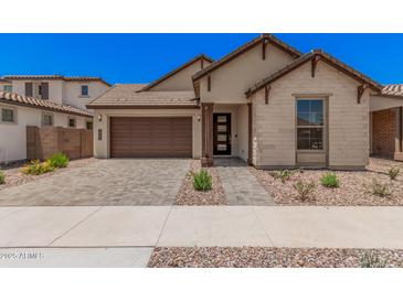 Charming single-story home featuring a two-car garage and well-manicured landscaping at 19354 S 212Th Pl, Queen Creek, AZ 85142