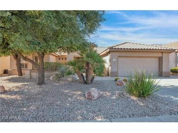 Charming single-story home with low maintenance desert landscaping, rock mulch and a two car garage at 19882 N Crimson Ridge Way, Surprise, AZ 85374