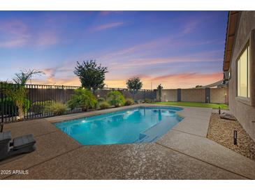 Inviting backyard pool with a private fence line, perfect for relaxing and entertaining outdoors at 21075 E Estrella Rd, Queen Creek, AZ 85142