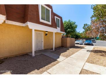Charming townhome featuring a secure front entrance and low-maintenance landscaping at 3350 W Las Palmaritas Dr, Phoenix, AZ 85051