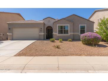 Charming single-story home with a well-manicured front yard and a two-car garage at 4108 N 304Th Ln, Buckeye, AZ 85396