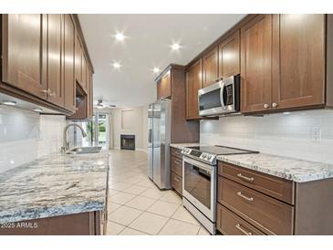 Well-lit kitchen with granite countertops and stainless steel appliances at 5998 N 78Th St # 116, Scottsdale, AZ 85250