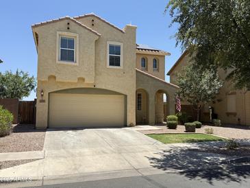 Charming two-story home with a stucco exterior, attached garage, and inviting curb appeal at 7321 S 48Th Dr, Laveen, AZ 85339