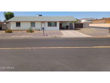 Charming single-story home with a driveway and simple, low-maintenance desert landscaping at 9726 E Quarterline Rd, Mesa, AZ 85207