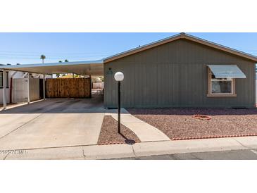 Charming home featuring a covered carport and low-maintenance landscaping at 10951 N 91St Ave # 84, Peoria, AZ 85345