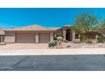 Beautiful single-story home featuring a tile roof, manicured landscaping, and a spacious three-car garage at 12120 E Cortez Dr, Scottsdale, AZ 85259