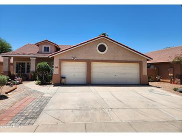 Charming single-Gathering home features a two-car garage, a tile roof, and well-maintained landscaping at 1643 E Oakland St, Chandler, AZ 85225