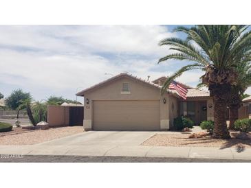 Charming single-story home featuring a well-maintained yard and two-car garage at 2004 N 108Th Dr, Avondale, AZ 85392