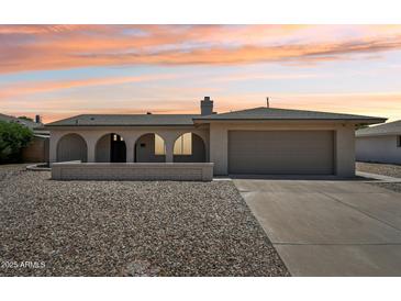 Charming single-story home featuring an arched entryway and a desert landscape at 2519 E Geneva Dr, Tempe, AZ 85282