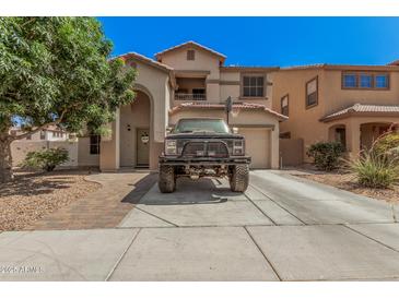 Two-story home with arched entry, balcony and basketball hoop over garage at 3625 W South Butte Rd, San Tan Valley, AZ 85144