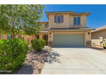 Charming two-story home with a well-maintained front yard and a two-car garage at 38191 W Merced St, Maricopa, AZ 85138