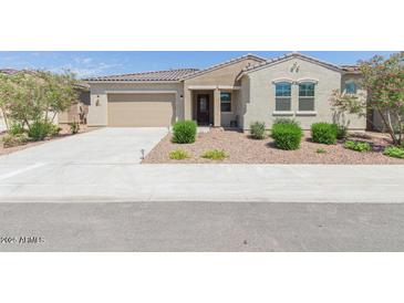 Charming single-story home featuring a well-maintained front yard and a neutral color scheme at 5139 N 185Th Ave, Litchfield Park, AZ 85340
