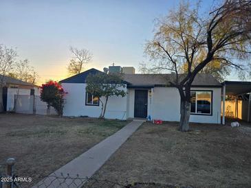 Charming single-story home features a neutral color scheme, small porch, and simple walkway at 6216 S 5Th Ave, Phoenix, AZ 85041