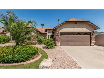 Beautiful home featuring mature landscaping and a two-car garage at 717 N Mckemy Ave, Chandler, AZ 85226