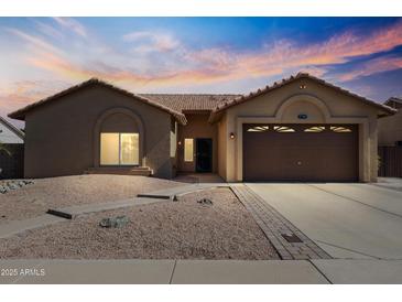 Charming single-story home with desert landscaping and a two-car garage, perfect for comfortable living at 7736 W Tumblewood Dr, Peoria, AZ 85382