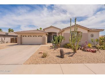 Charming single-story home with desert landscaping, a two-car garage and a tile roof at 16781 W Northampton Rd, Surprise, AZ 85374