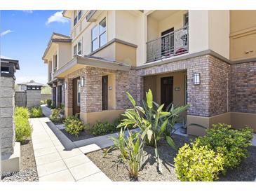 Charming townhome exterior with brick accents, lush landscaping, and inviting walkways create curb appeal at 17850 N 68Th St # 1017, Phoenix, AZ 85054