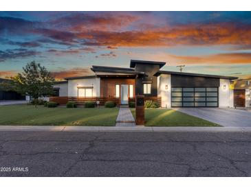 Stunning modern home featuring unique architectural details, wood accents, and a stylish three-car garage at 2215 N 38Th Way, Phoenix, AZ 85008
