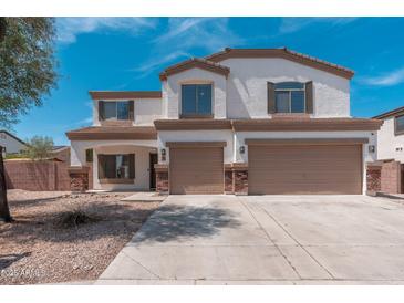 Two-story home featuring a two-car garage, white stucco, and brown trim at 22966 W Hopi St, Buckeye, AZ 85326