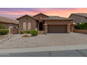 Charming single-story home features a tile roof, stone accents and a two car garage at 6936 E Snowdon St, Mesa, AZ 85207