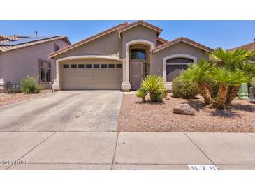 Charming single-Gathering home with a two-car garage, desert landscaping, and covered entryway at 878 E Mountain View Rd, San Tan Valley, AZ 85143