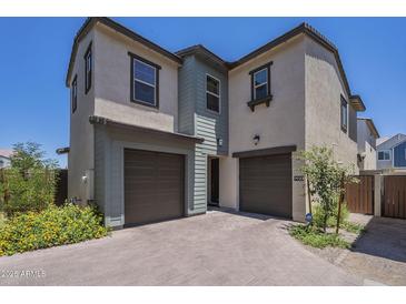 Charming two-story home featuring a two-car garage and a beautifully paved driveway at 9920 E Tamery Ave, Mesa, AZ 85212