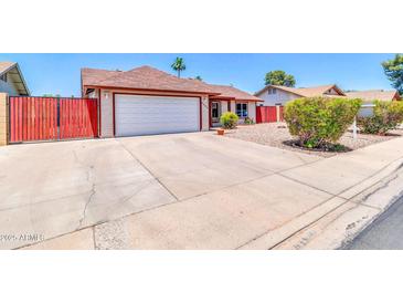 Charming single story home featuring a well-kept front yard and a two-car garage at 2324 E Crescent Ave, Mesa, AZ 85204
