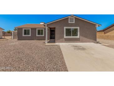 Charming single-story home featuring a desert landscape, concrete driveway, and neutral paint scheme at 3056 N 68Th Ln, Phoenix, AZ 85033